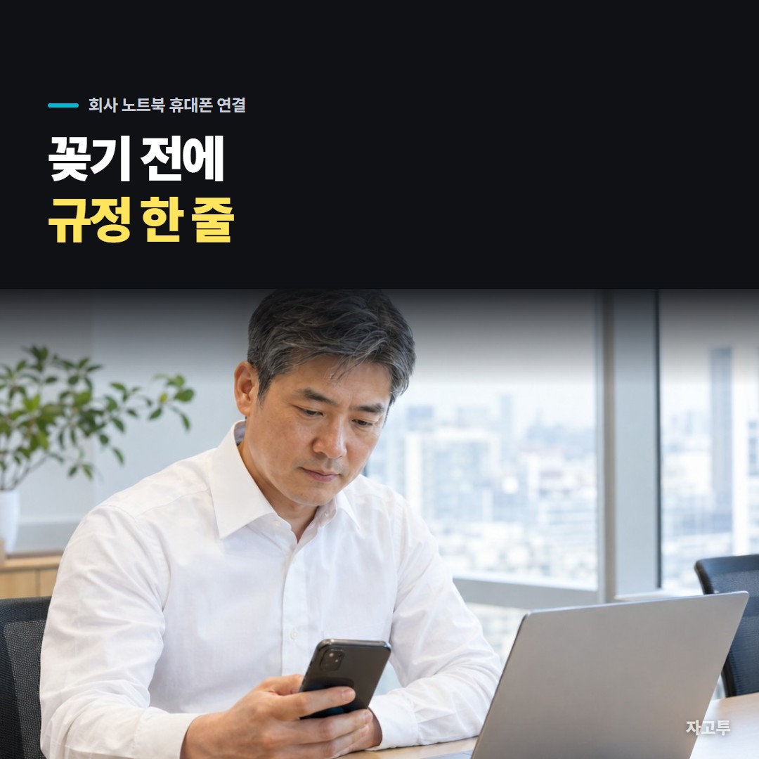 회사 노트북 앞에서 개인 휴대폰을 들고 케이블을 꽂을지 망설이는 장면
